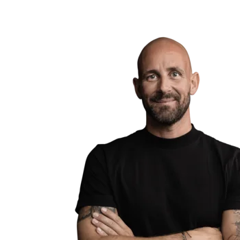 The best references for our hotel marketing Smiling bald man with tattoos wearing black shirt on white background