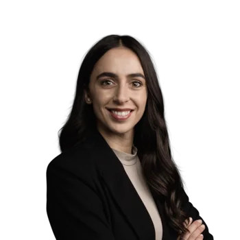 Marilena Grünfelder | Head of Sales Porträt einer lächelnden Frau mit schwarzem Blazer und langen dunklen Haaren