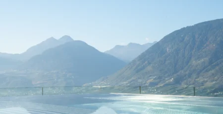 The best references for our hotel marketing Infinity pool overlooking mountains under clear blue sky