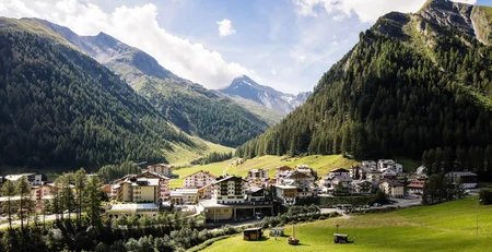 The best references for our hotel marketing Mountain village surrounded by green forests and mountains under clear sky